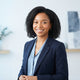 A friendly, smiling woman with a professional appearance, representing a satisfied customer in a clean, bright studio setting
