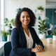 A friendly, smiling woman in a professional setting, representing a satisfied and happy customer.